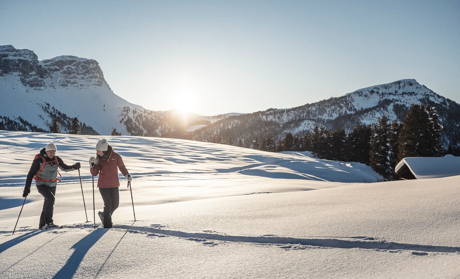 Snowshoers in front of the distinctive Geisler peaks in Puez-Geisler Nature Park South Tyrol