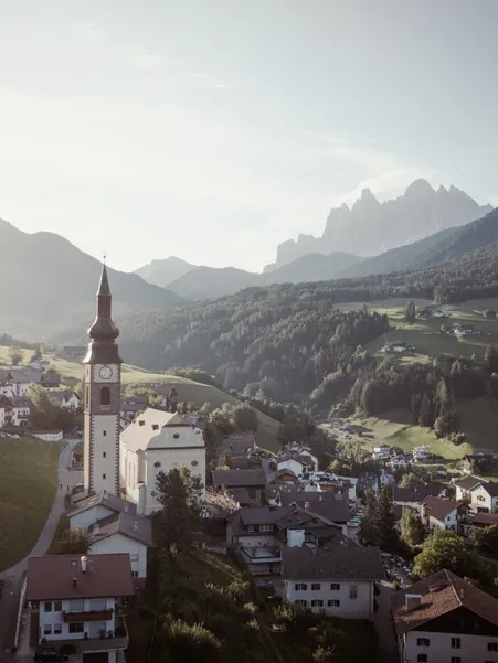 St. Peter in Villnöß: baroque parish church with slender bell tower, landmark of the municipality in the Isarco Valley