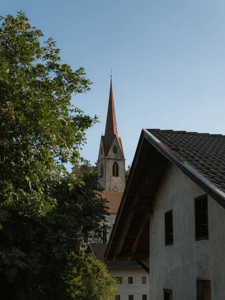 Teis in Villnöß valley: historic village church and vineyards at the entrance to UNESCO World Heritage Dolomites
