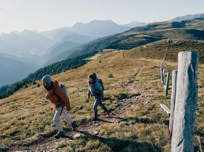 Hiker on Luson Alp with mountain panorama – idyllic alpine landscape and extensive hiking trails in South Tyrol